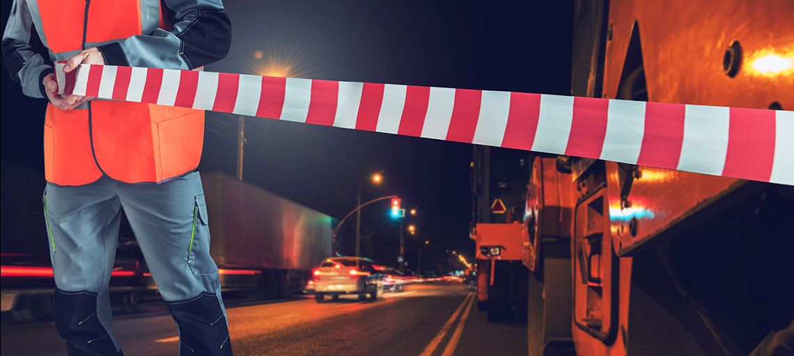 A person holding tape near a safety zone.